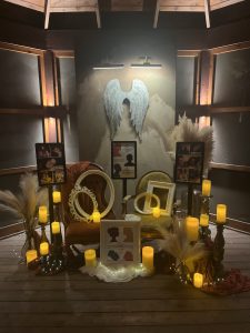 display of picture frames, angel wings, and candles